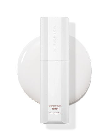 A white wireless charging pad with a cylindrical toner cartridge placed on top
