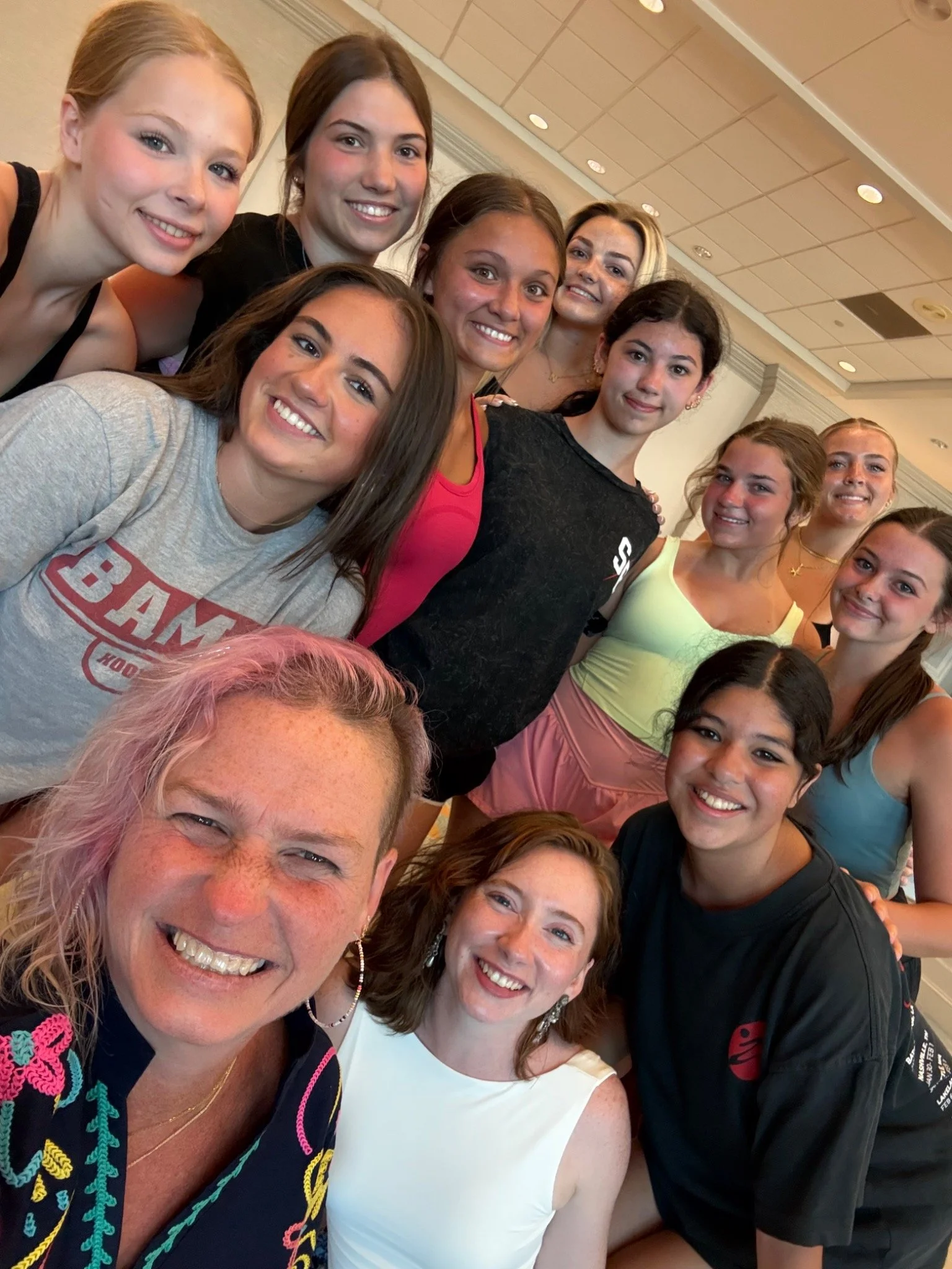 Smiling TTP dancers and teacher together in the studio