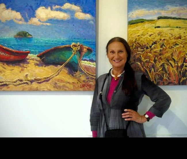   Ute Hagen with her paintings "La Pe&ntilde;ita", left and "Summer Wheat", right  