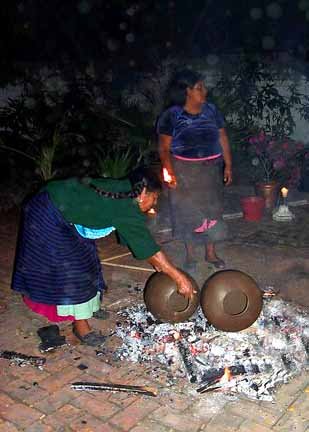 indigenous Purepecha women setting pots to be fired