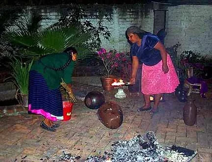 Purepecha women firing clay pottery in open fire 
