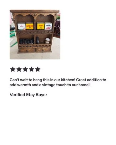 Vintage wooden spice rack with three shelves holding spices and condiments, set on a kitchen counter.