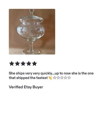 A glass container with a lid, filled with white bath salts, placed on a wooden surface.