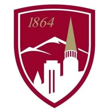 A shield-shaped emblem with the year 1864, mountains, a tall spire, and city buildings in white on a maroon background.