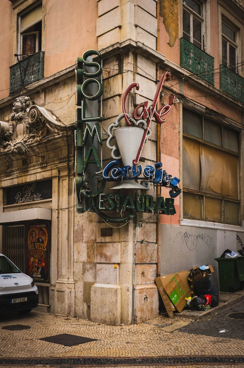 Neon signs of the Solmar café and restaurant on the corner of a weathered Lisbon building