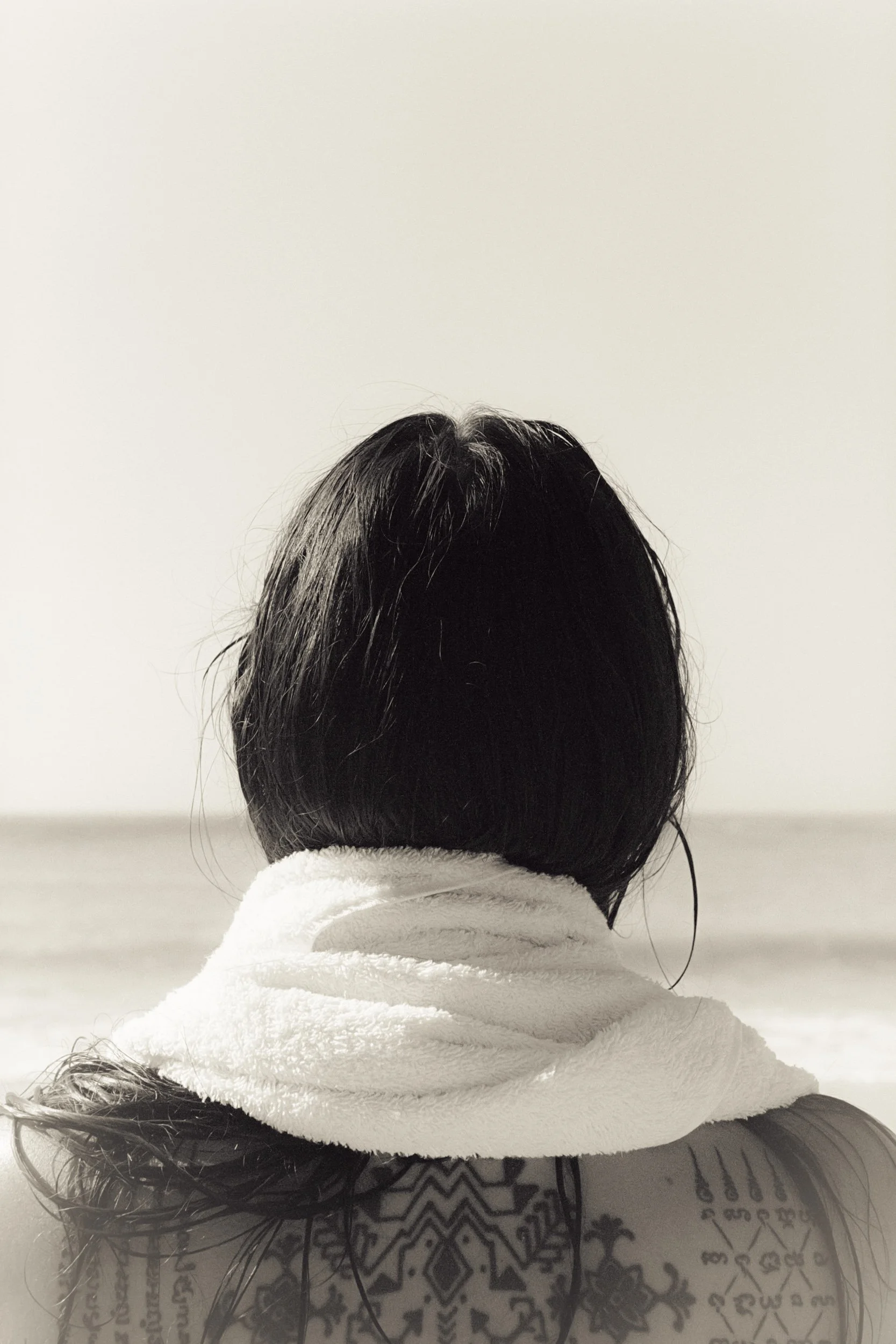 Seen from behind with a towel around the neck, black and white, 35mm film
