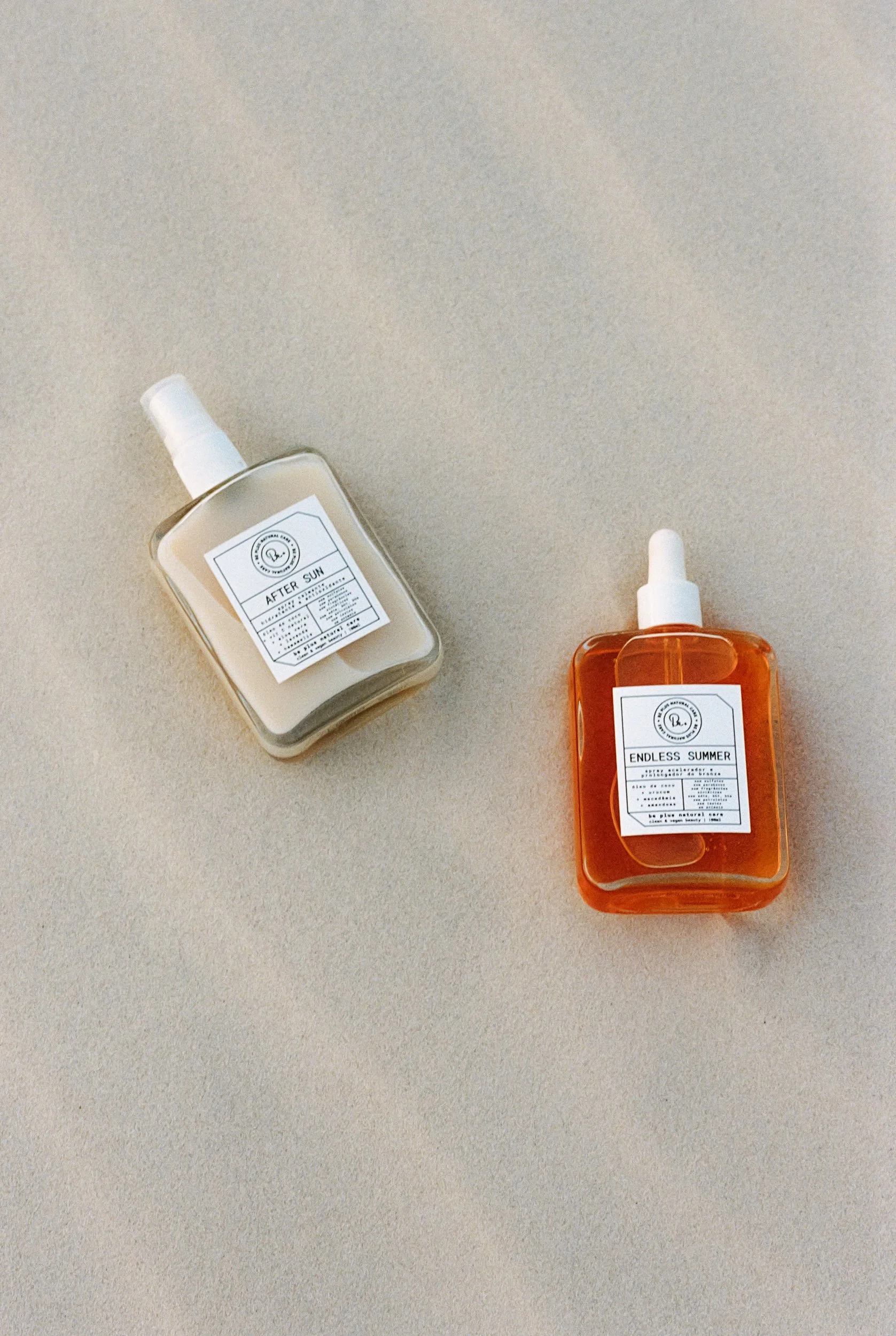 After Sun and Endless Summer products bottles lying flat side by side on white sand, Be Plus Natural Care, Lençóis Maranhenses, Brazil, on 35mm film.