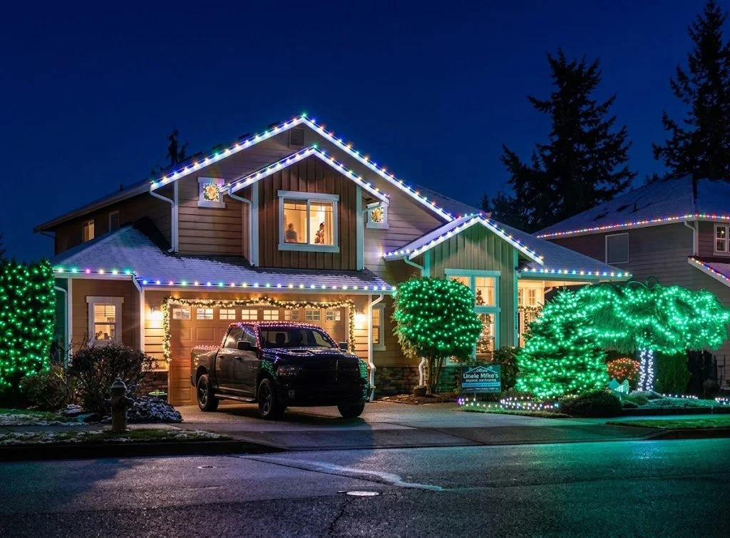Christmas roofline lights installed on a home with warm white bulbs for holiday decoration