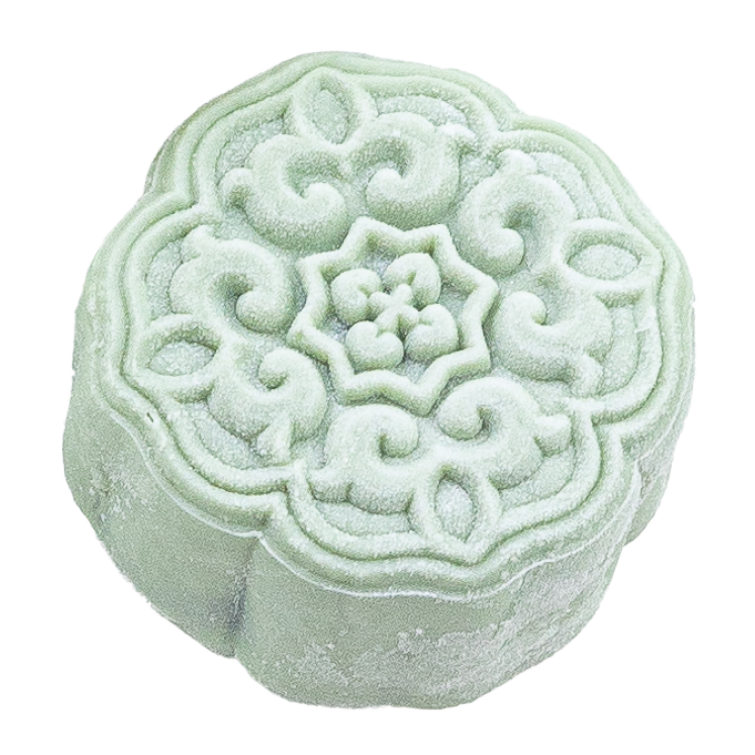 A pale green mooncake with intricate floral and swirl patterns on top.