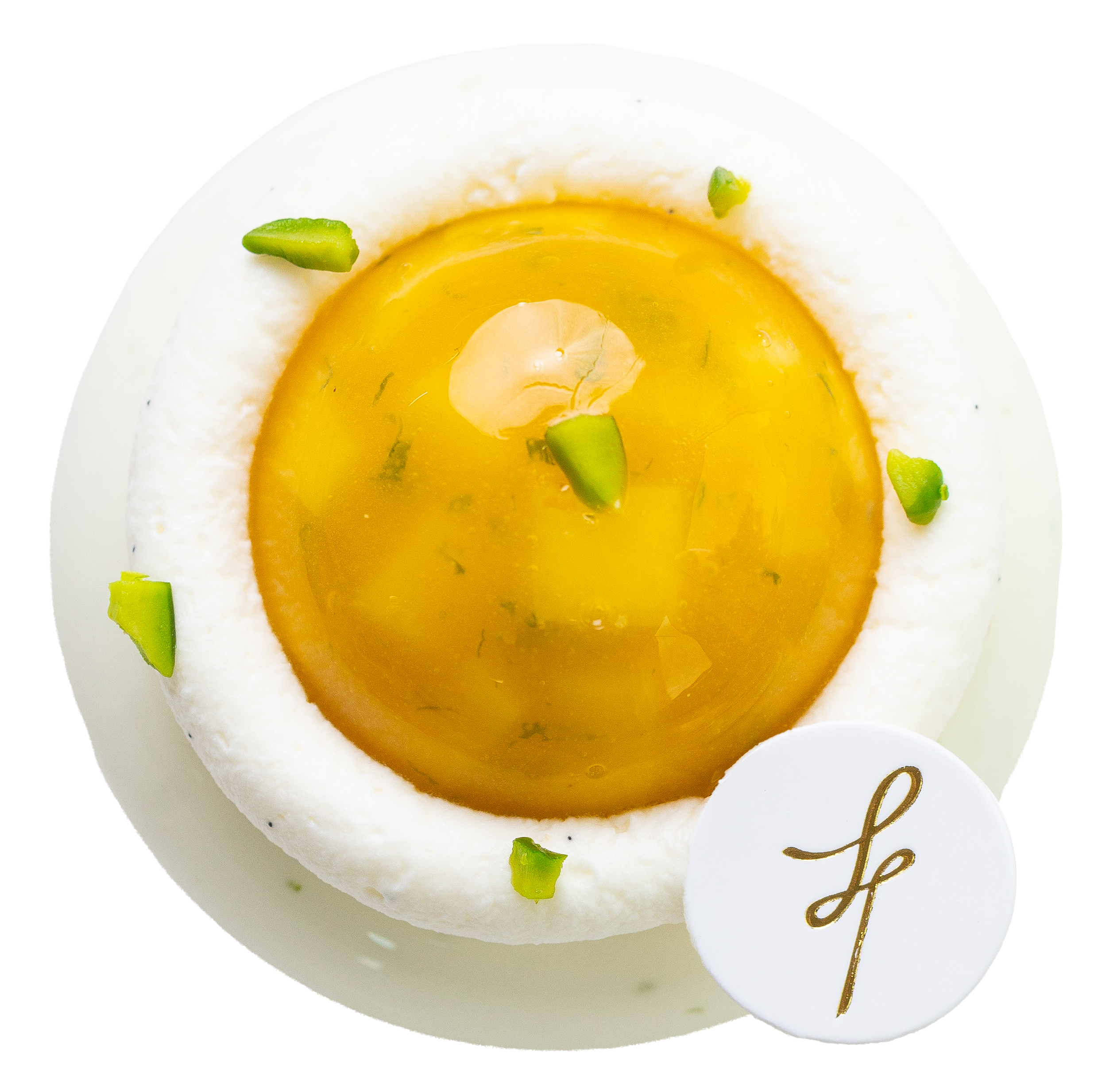 Close-up of a decorated cake with white icing, green garnish pieces, and gold cursive lettering on the side.