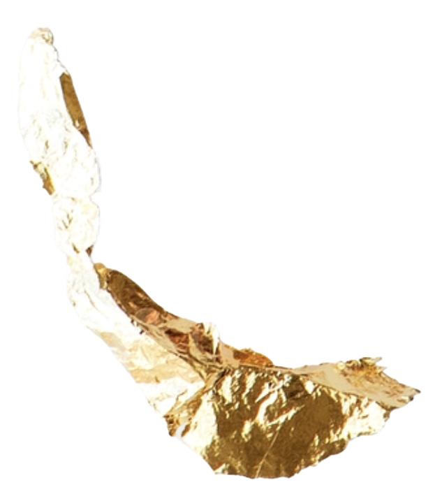 Partial view of a gold foil wrapped item, possibly a snack or pastry.