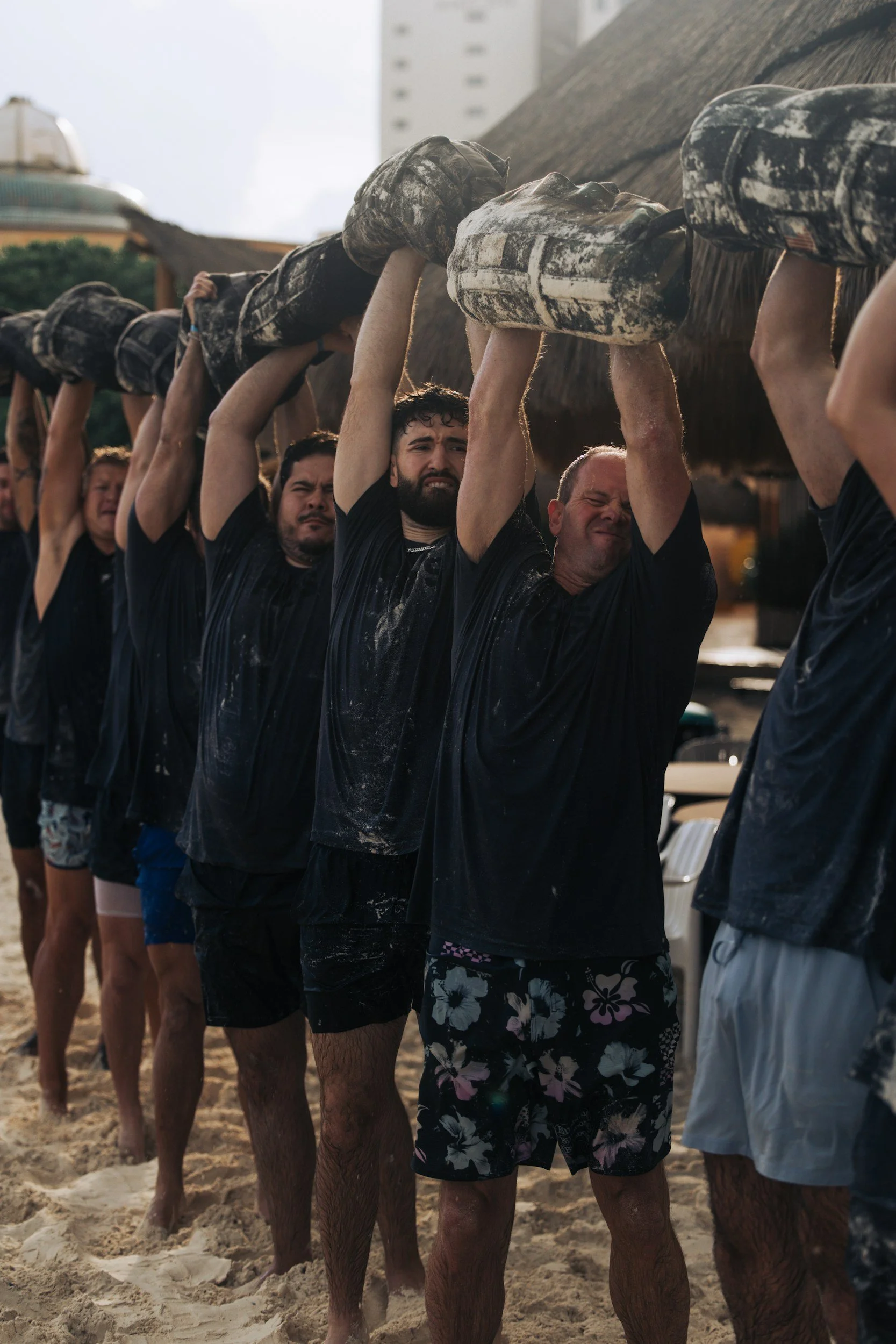 Team carrying a log together during an outdoor group training session.