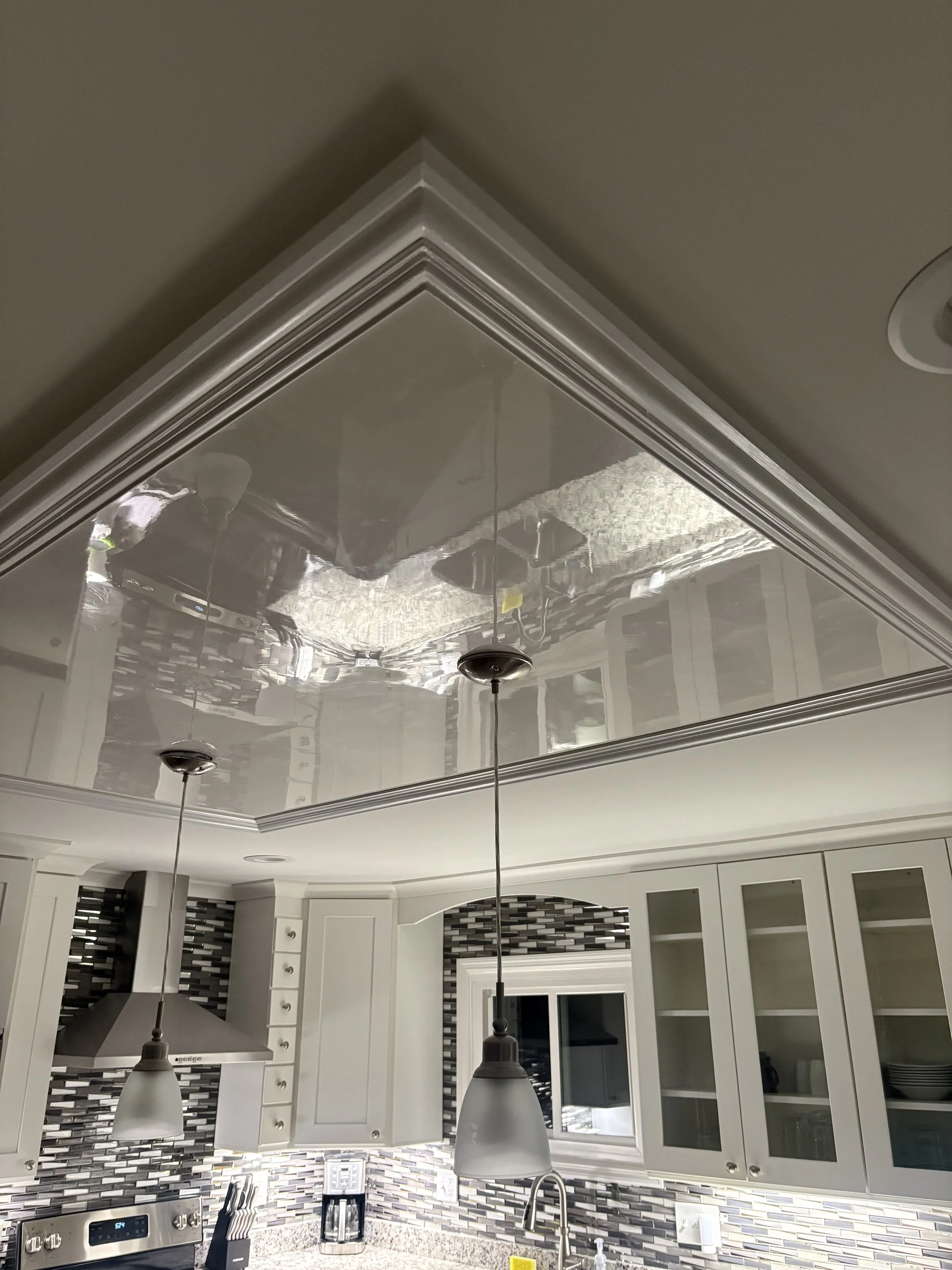 Mirror-polished Venetian plaster ceiling inset in a St. Louis kitchen.