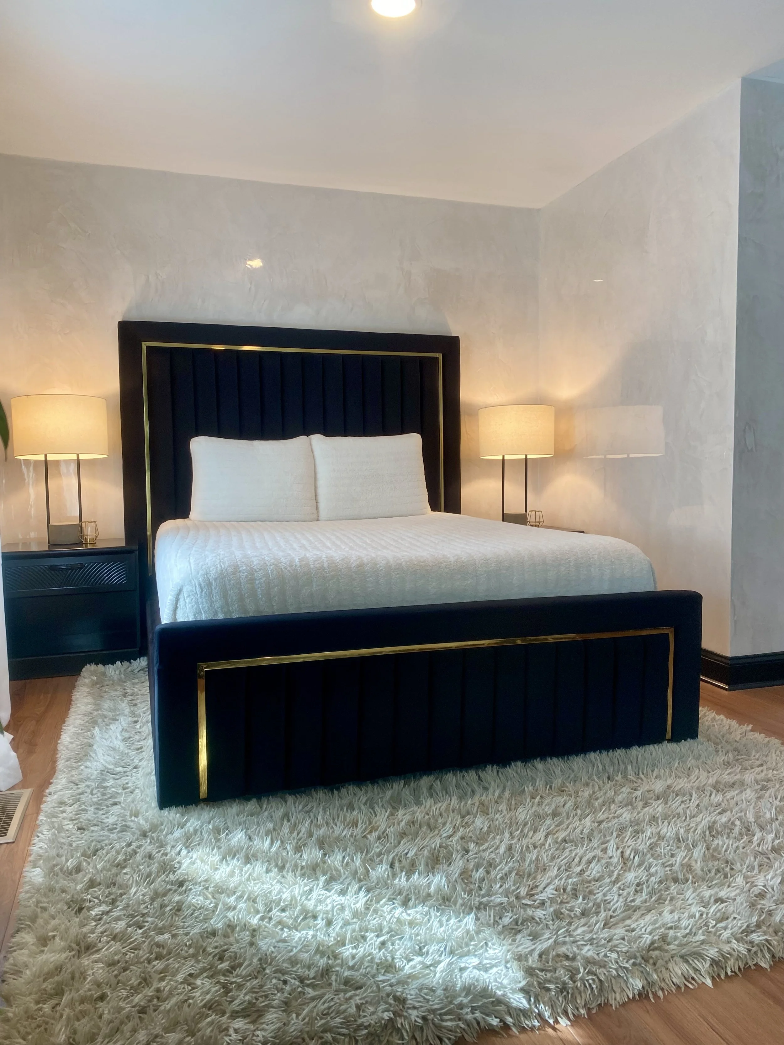 Hand-applied Venetian plaster bedroom walls with a soft, reflective finish.