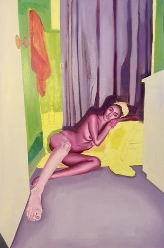 A woman with long dark hair is sitting on the floor with her back against a yellow sofa, positioned in front of purple curtains. She appears to be nude, with one leg stretched out and the other bent, and she rests her head on her arm while looking fo