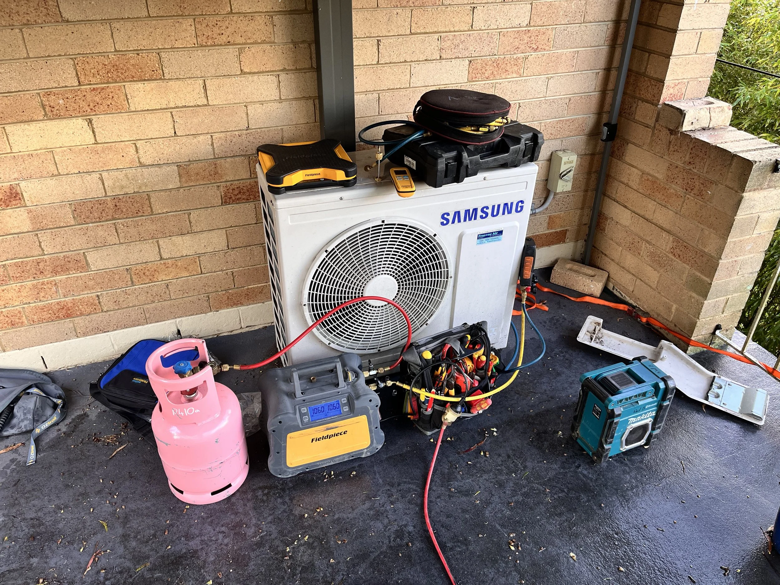Refrigerant recovery equipment set up beside a Samsung outdoor unit