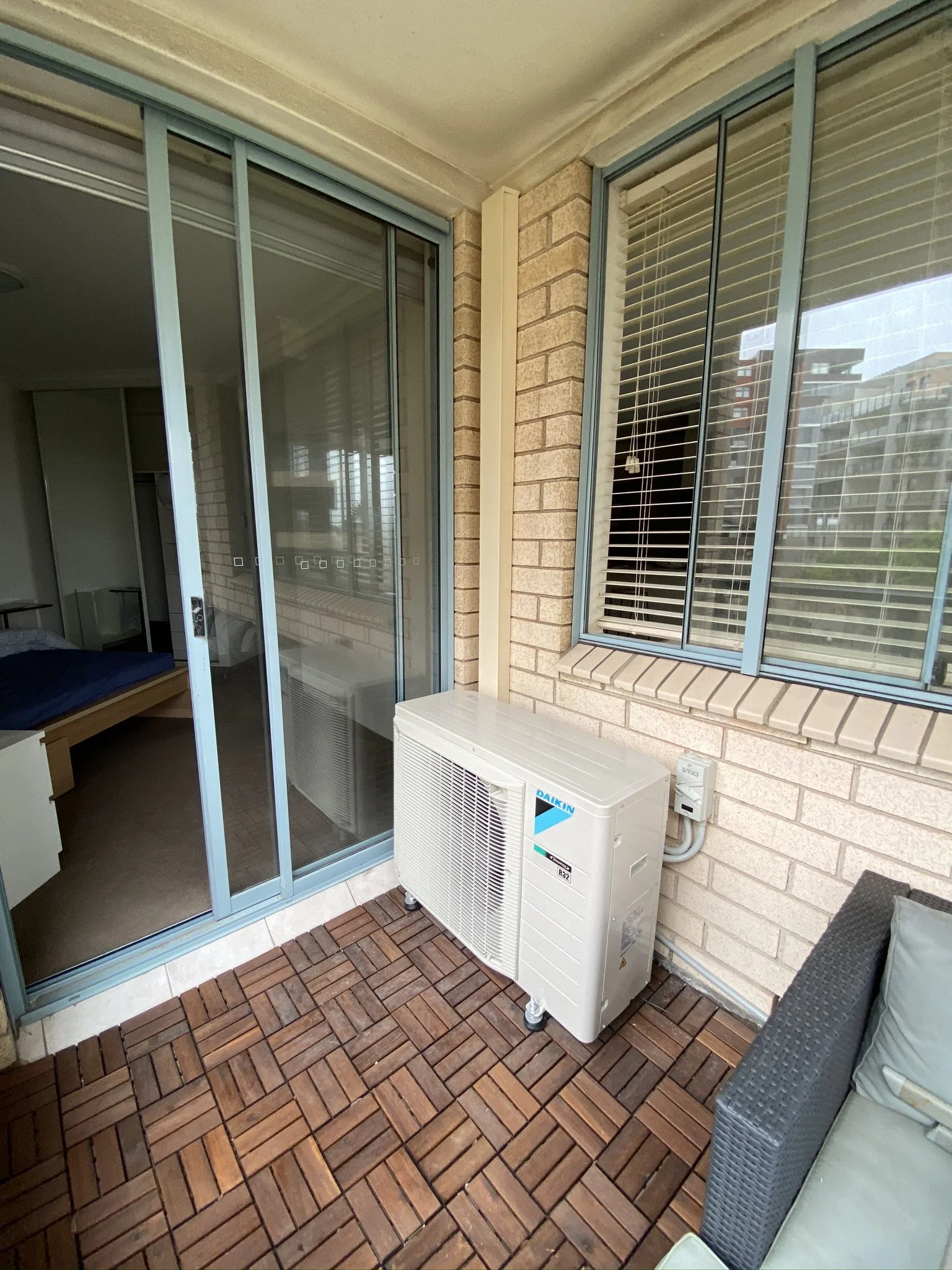 Air conditioner outdoor unit on an apartment balcony