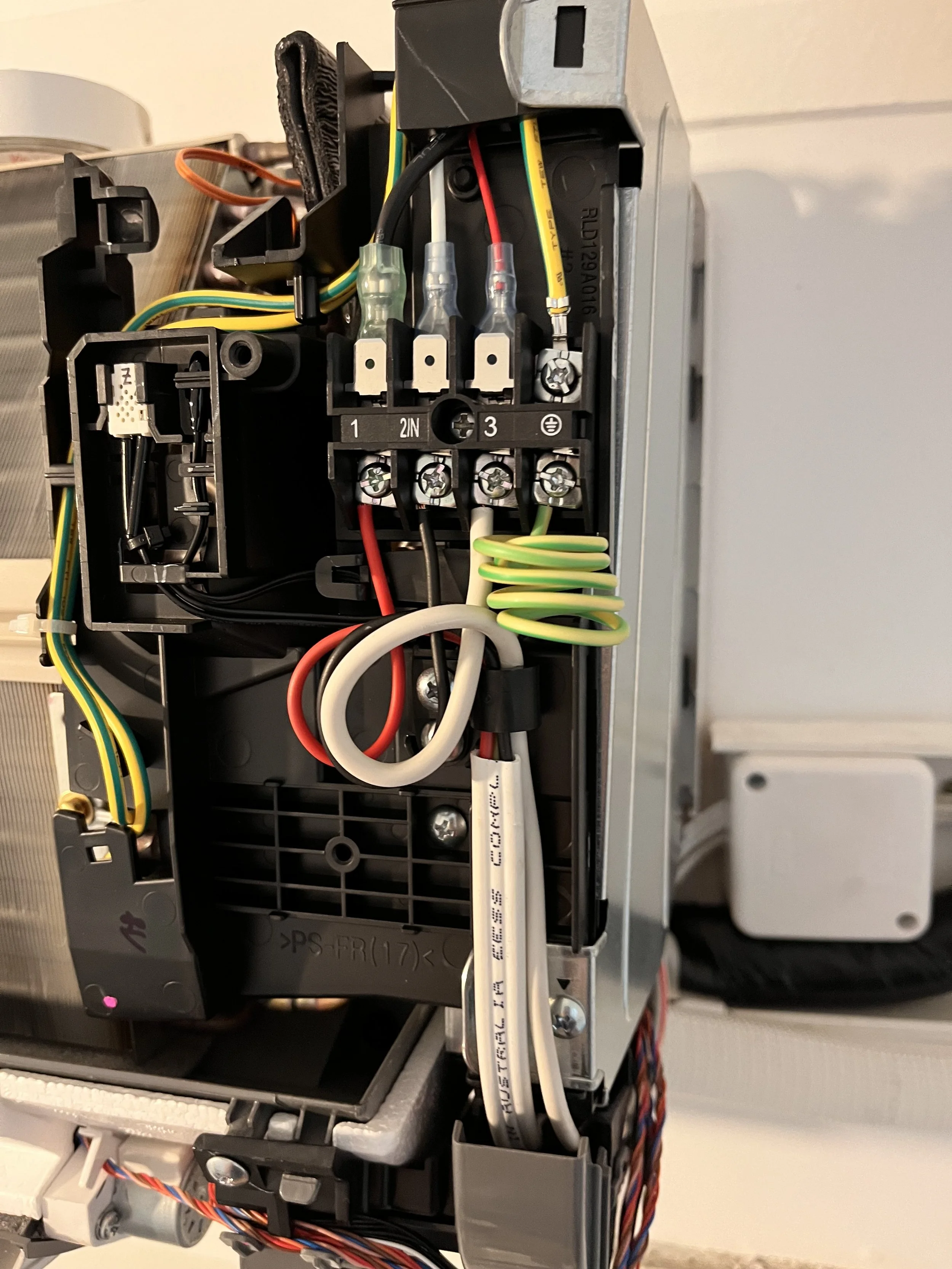 Terminal block and wiring inside an air conditioner's electrical compartment