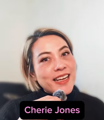 A woman with short hair speaking into a microphone with a text overlay saying "Cherie Jones".