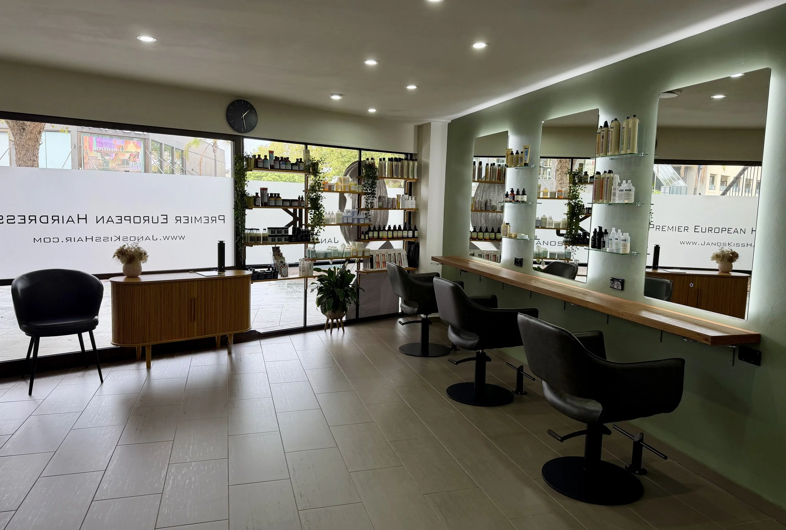 Interior of Janos Kiss Hair, a boutique hair salon on Military Road, Cremorne, Sydney, with styling chairs and backlit mirrors