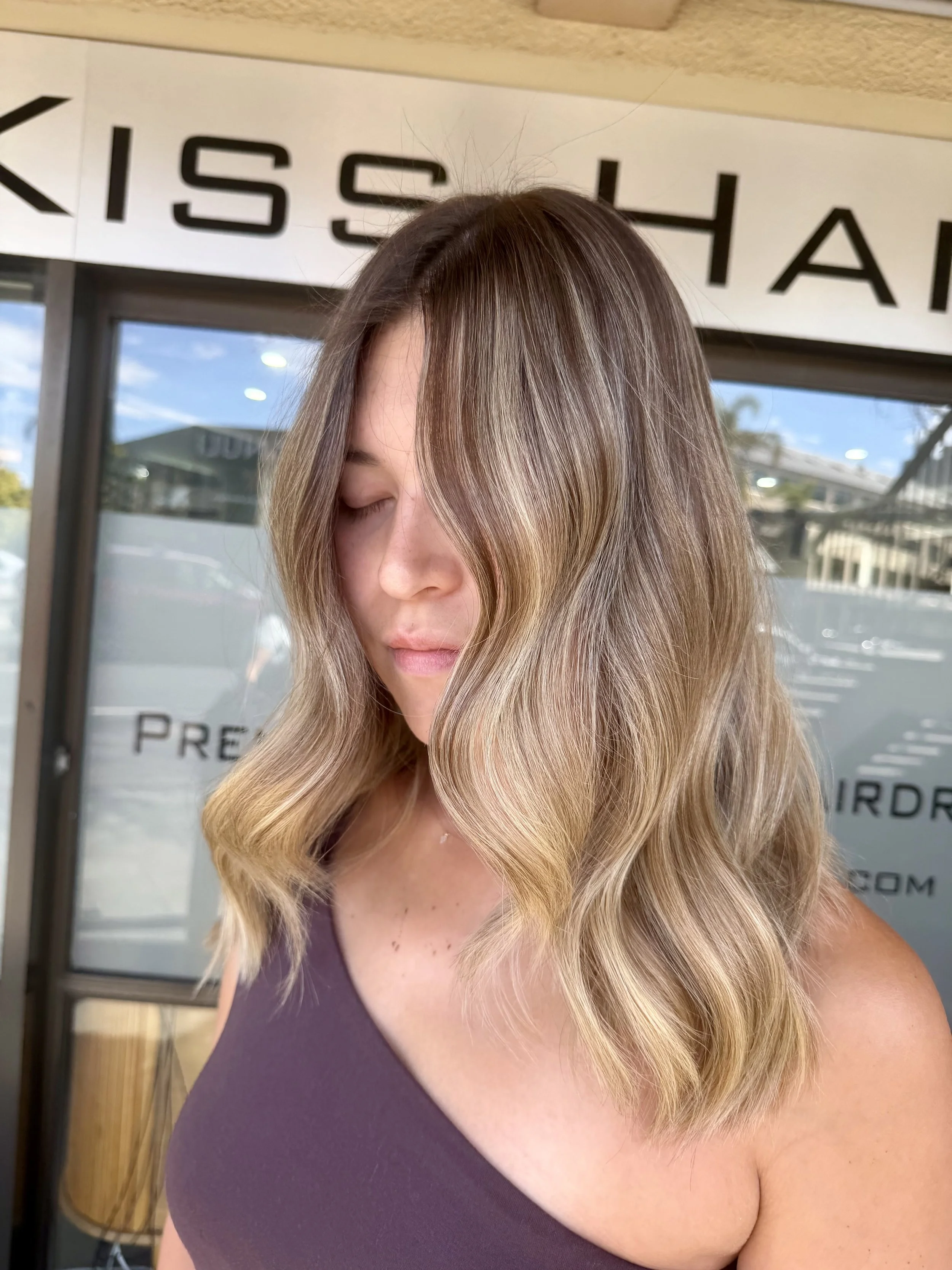 Lived-in blonde balayage on wavy shoulder-length hair, colour by Janos Kiss Hair, Cremorne