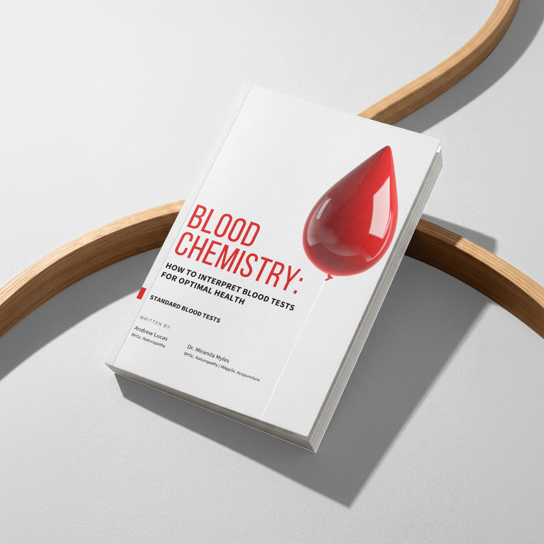 Book titled 'Blood Chemistry,' with a red blood drop illustration on the cover, placed on a white surface with wooden accents.