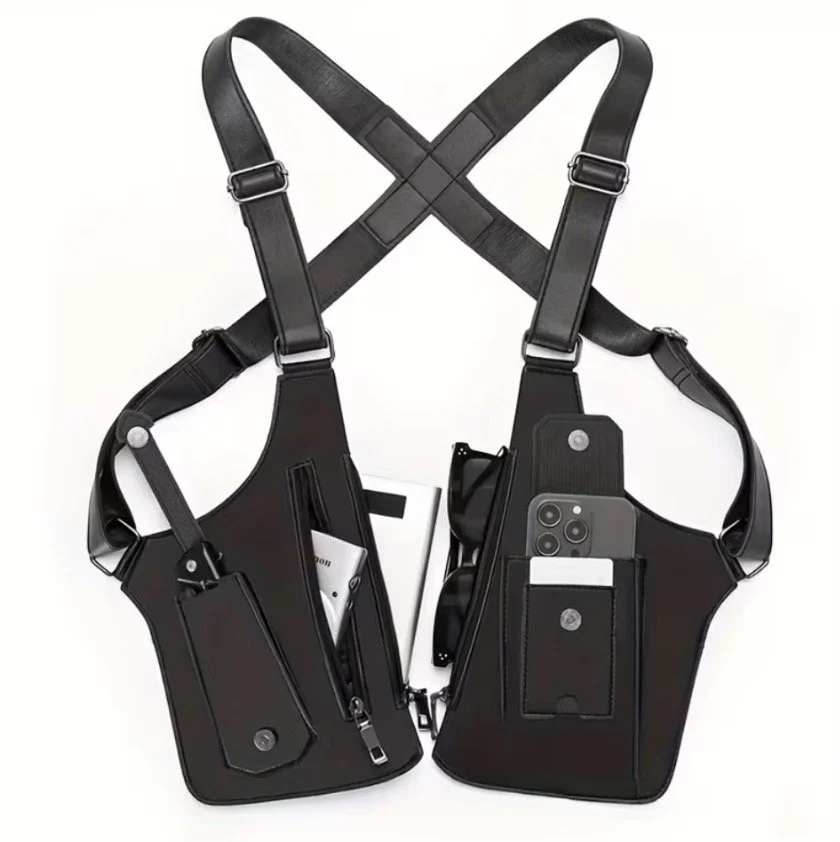 Black tactical chest rig with multiple pockets and straps holding a smartphone, sunglasses, and small items against a white background.