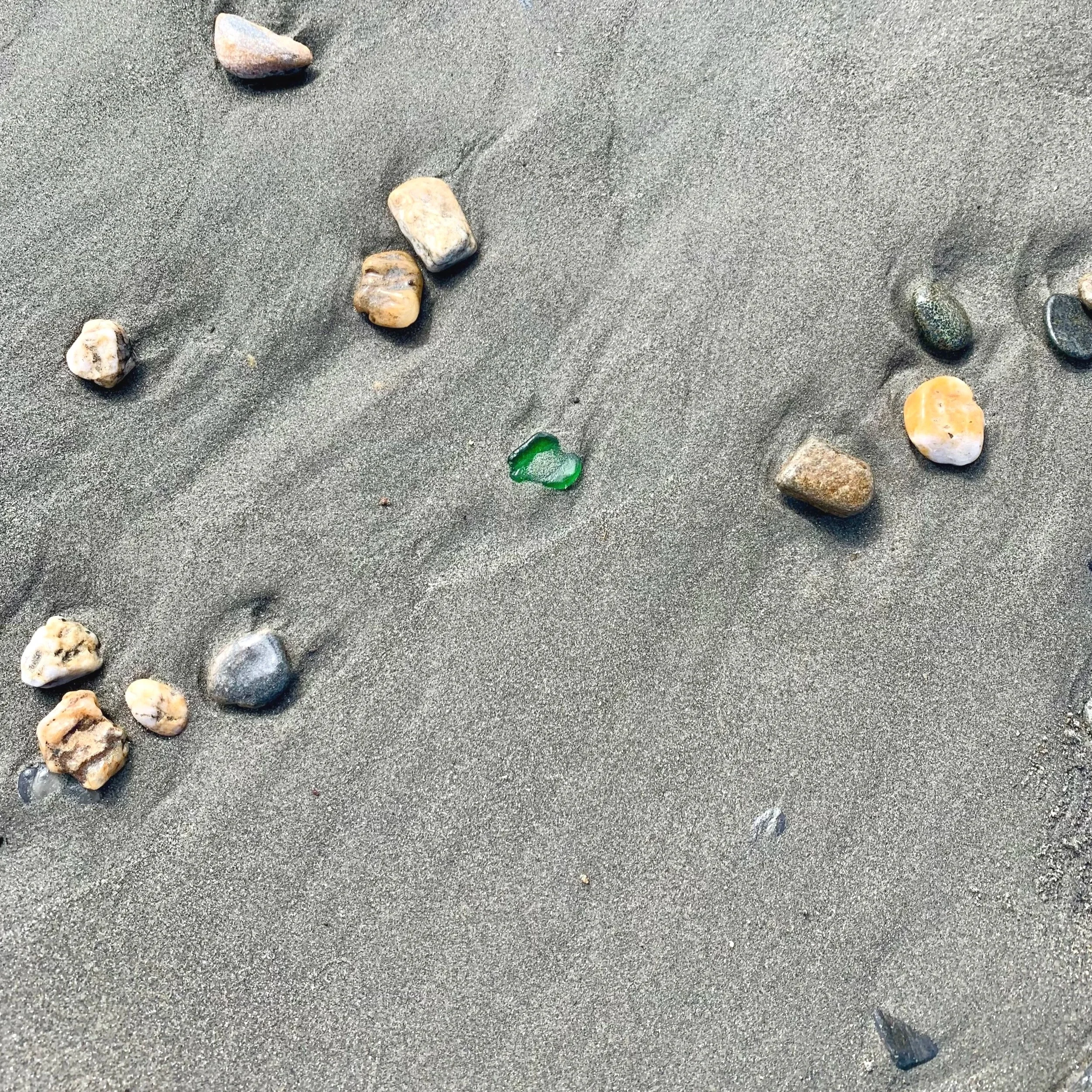A sea glass hunting beach in Nome, Alaska, scattered with small rocks and pebbles.