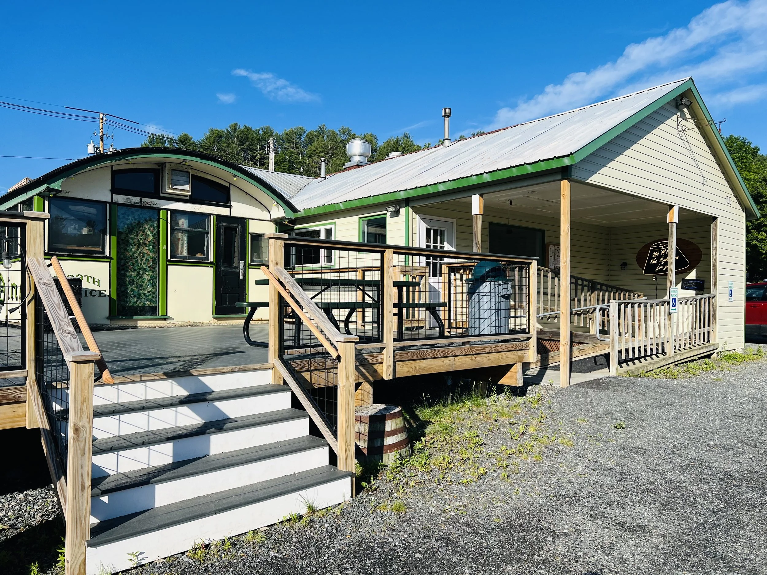 Exterior of Royal Diner at 487 Marlboro Rd, West Brattleboro VT, with green trim and wooden deck