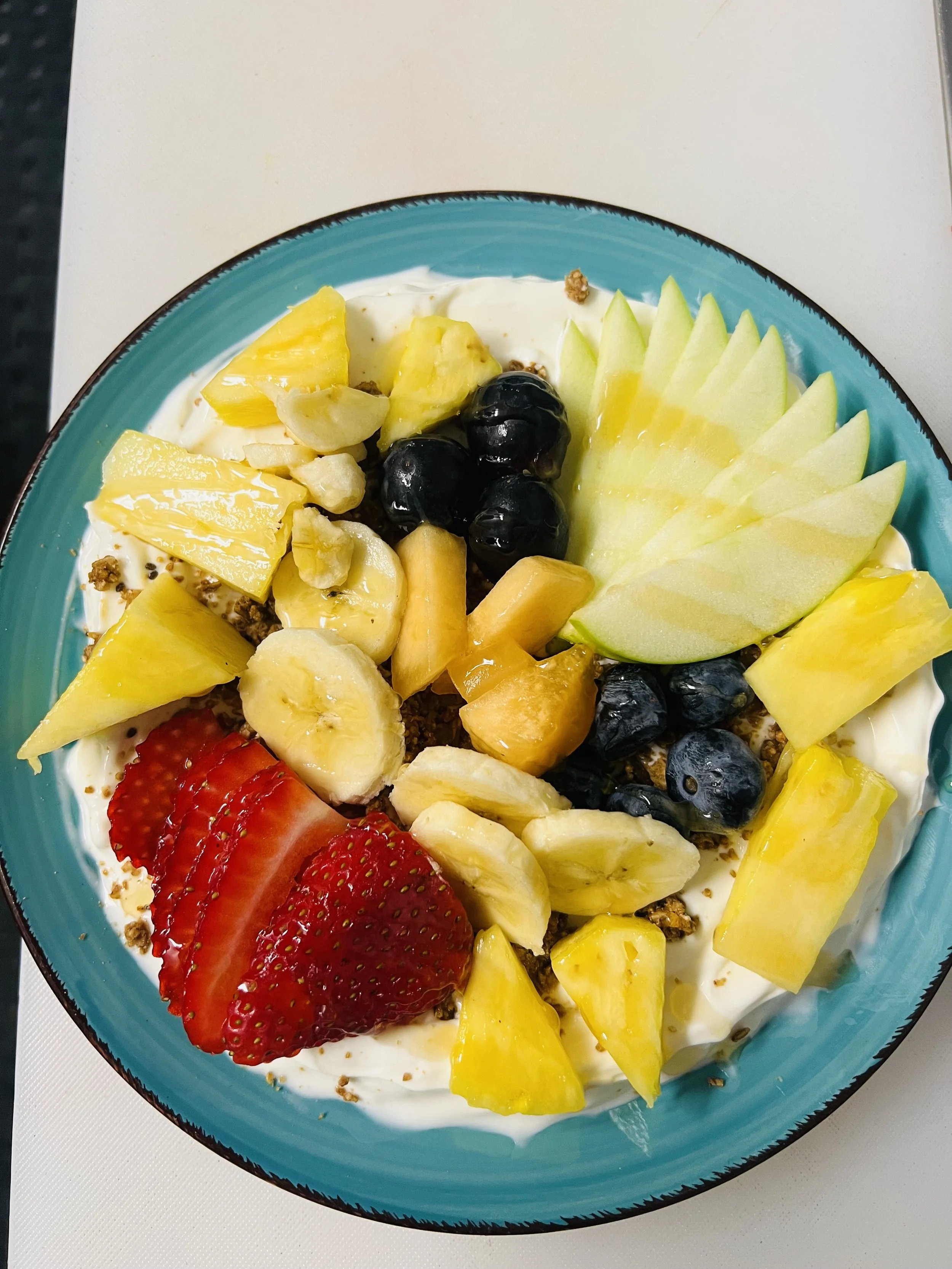 Yogurt bowl with fresh strawberries, blueberries, pineapple, melon and banana at Royal Diner