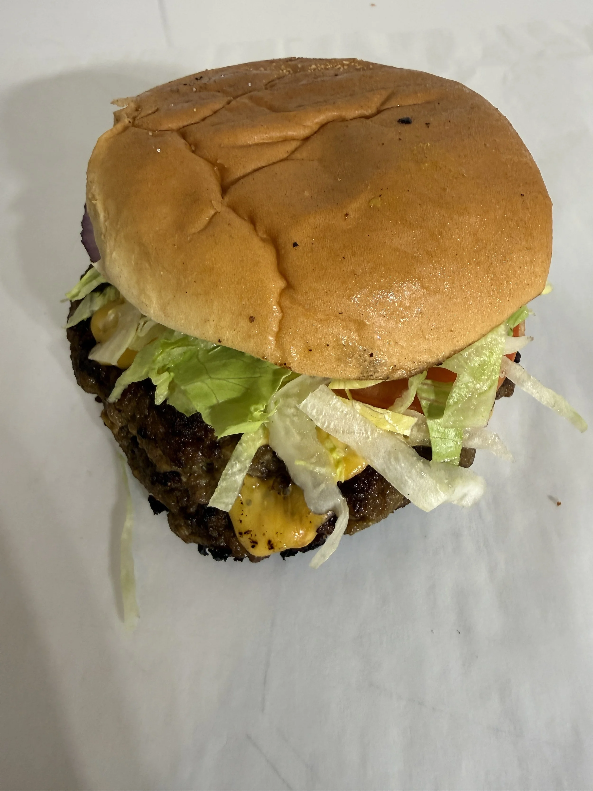 Close-up of a cheeseburger with lettuce and tomato at Royal Diner, West Brattleboro VT