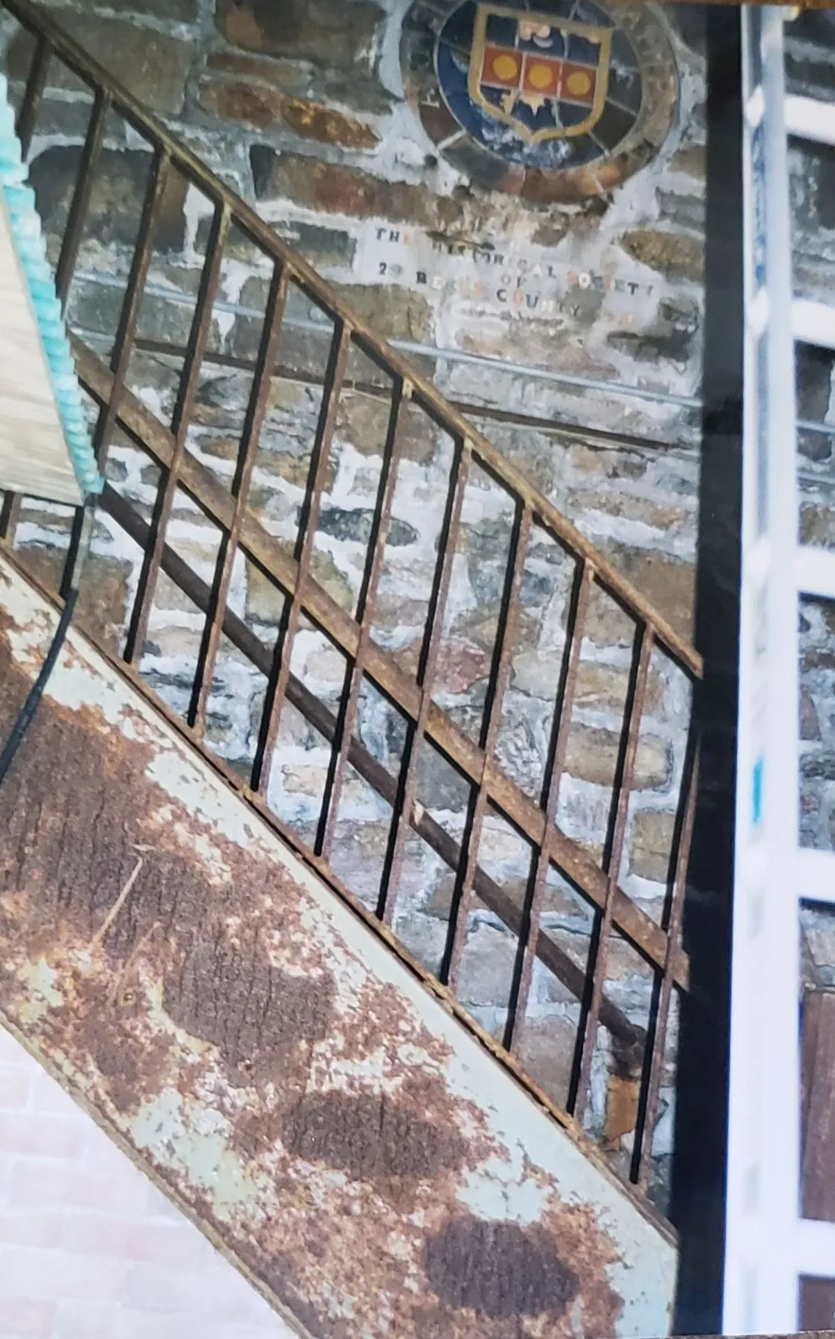 The steel stairs inside the William Penn Memorial Fire Tower shown rust damage in 1999. The Penn family crest, made from tile is in the upper portion of the image. The stairs were restored by Bachman Iron Works in 2000. (Corrie Crupi Zana — Pagoda-Sk