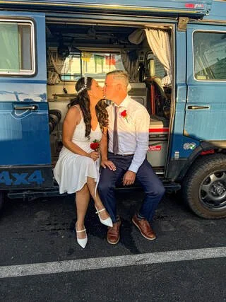 Shane and Karen on their wedding day beside their Volkswagen van