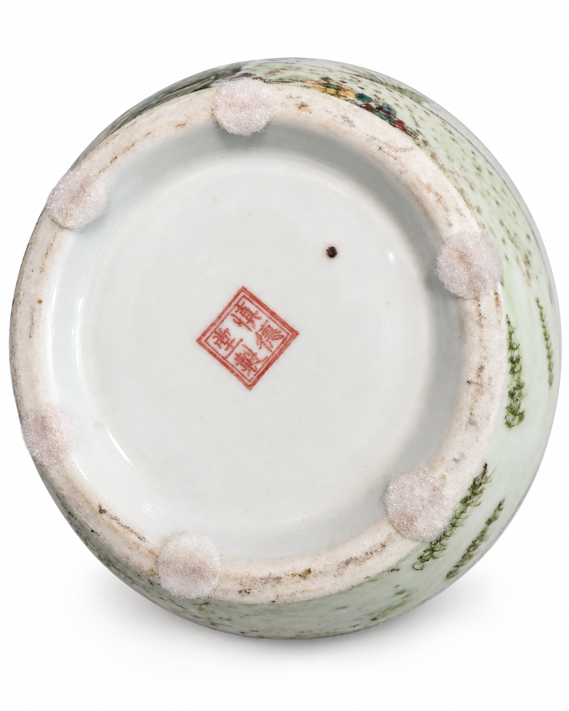Porcelain vase underside showing a red square mark, protective pads and wear around the circular foot.