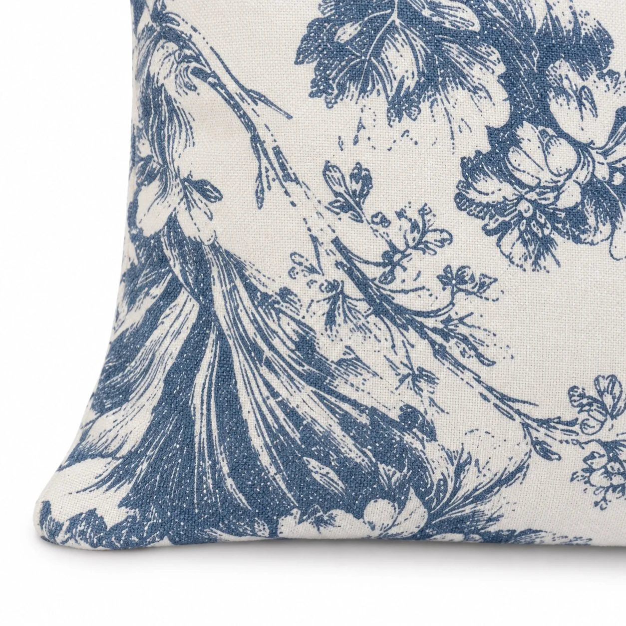 Angled front view of the blue botanical pillow on white.