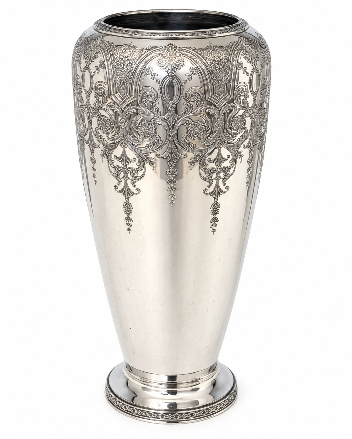 Decorative silver-plated vase with embossed Paisley design displayed in a French-inspired interior vignette.