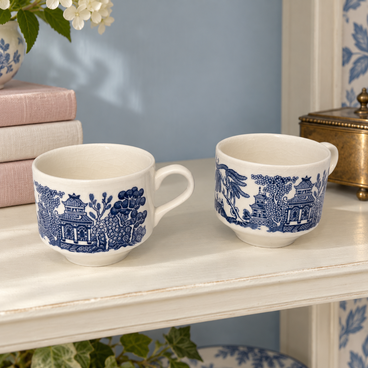 Detail of Blue Willow decoration and glaze crazing on a cream ceramic cup.