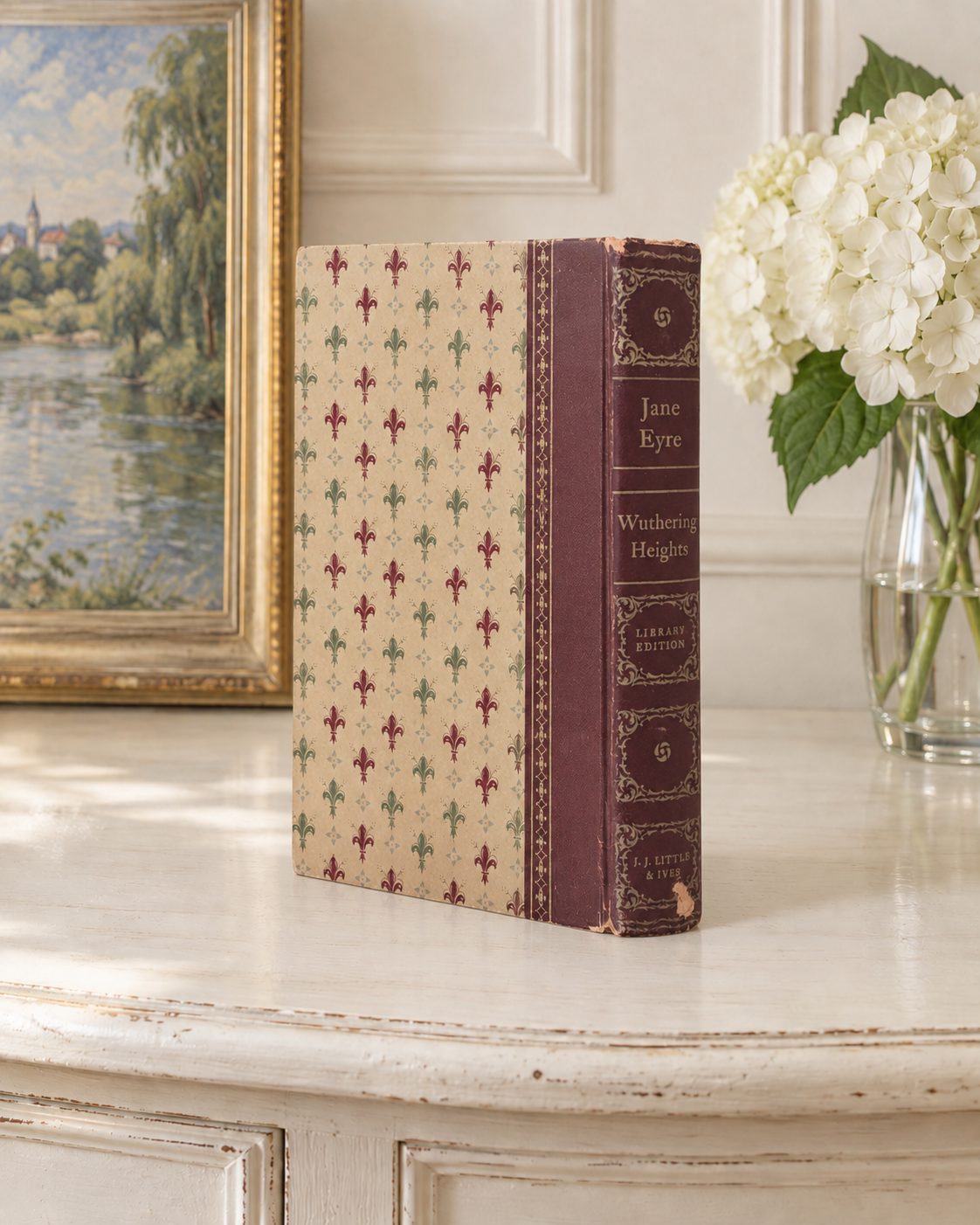 Jane Eyre and Wuthering Heights spine with faded gold decoration and chipped covering.