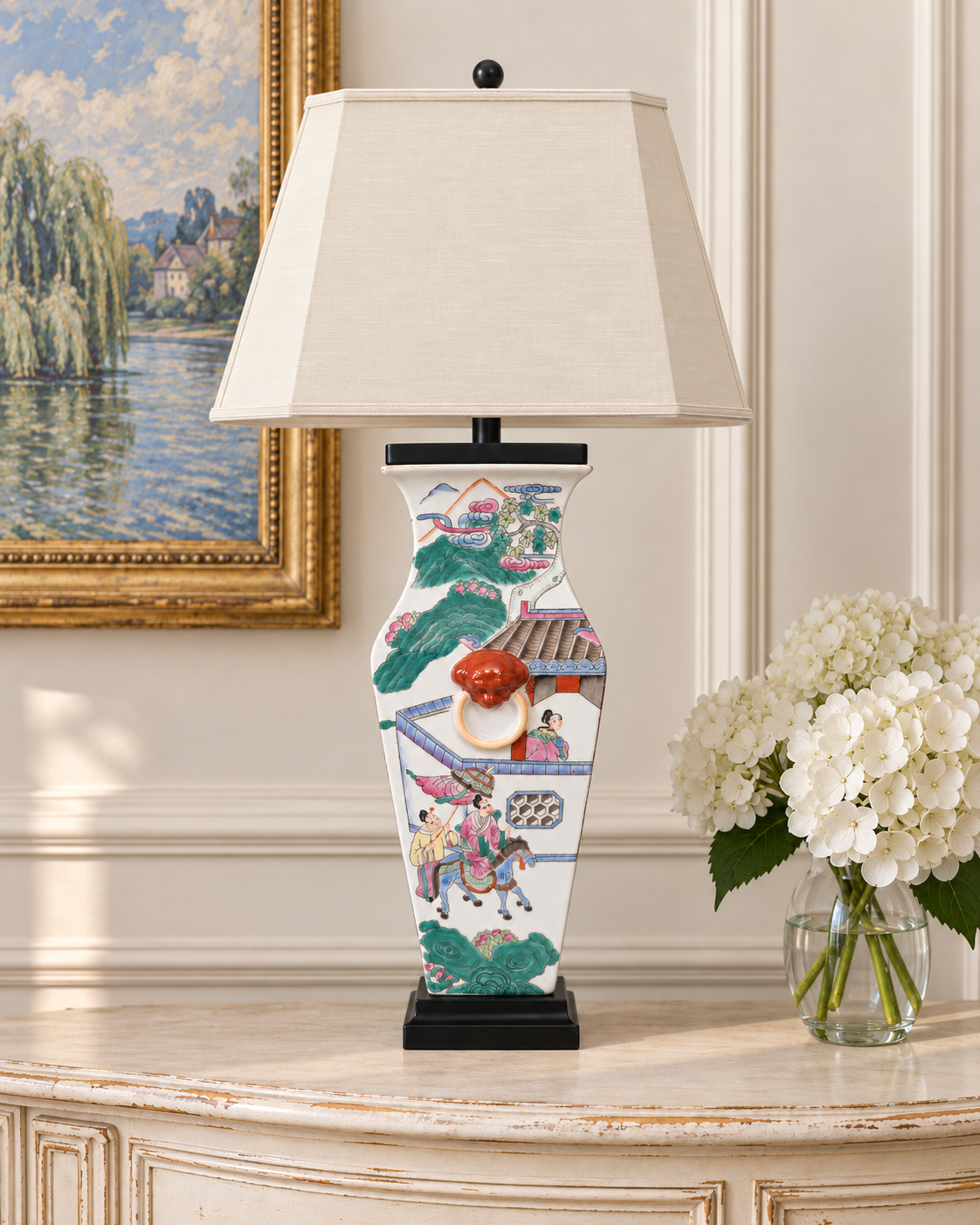 Shop this chinoiserie famille rose style porcelain table lamp with lion handles and colorful figural scenes at Maison Boudreau. Shade not included.