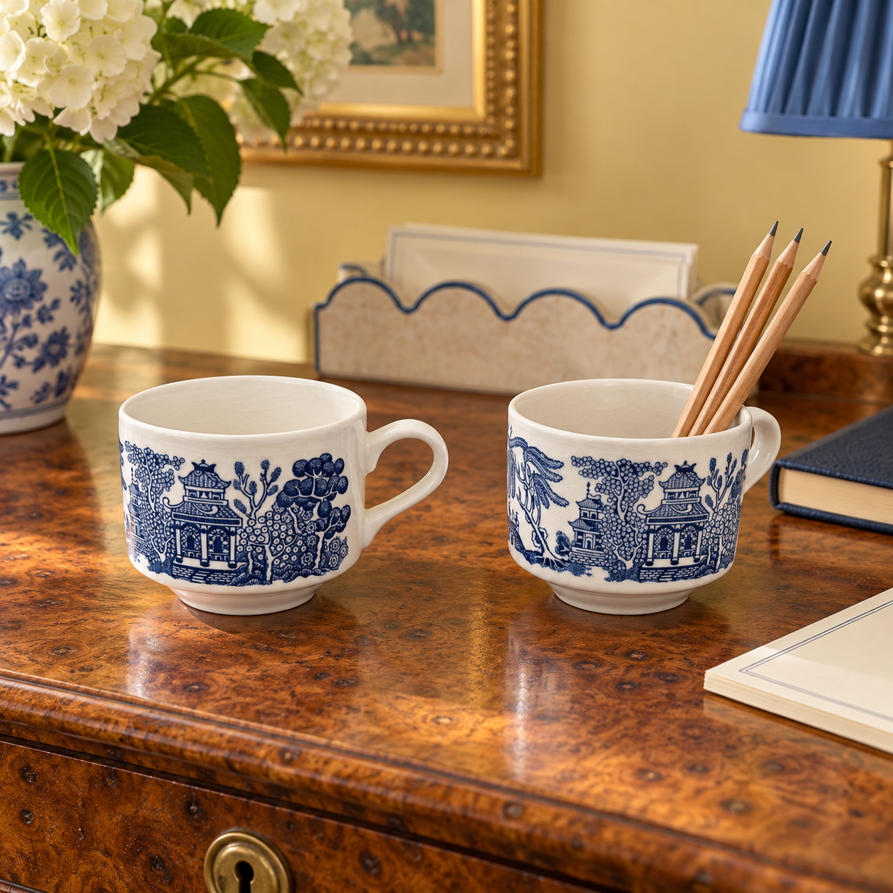 Blue Willow cup pair styled on a shelf in a grandmillennial interior.