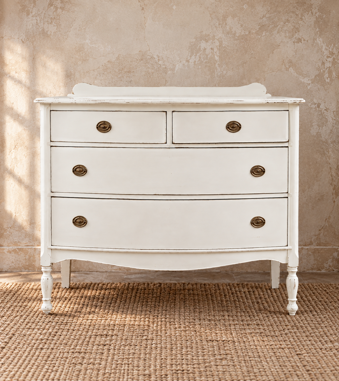 This sweet bow-front chest was the first piece I ever sold through The Midwest Cottage. Its gently curved front, two-over-three drawer layout and turned feet draw from Regency and Sheraton furniture traditions. I refinished it in a simple soft white,
