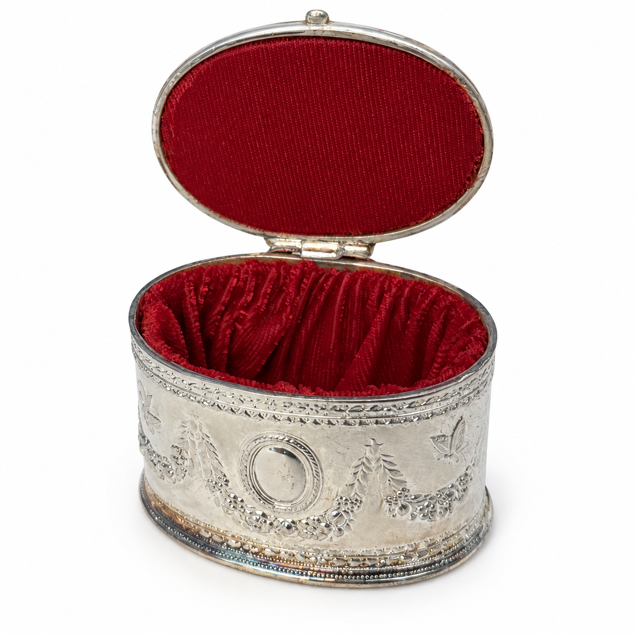 Tape measure across the width of the small oval metal trinket box.