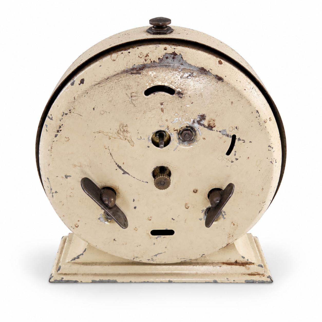 Rear of the cream Broadcast clock showing winding keys, adjustment controls and worn metal finish.