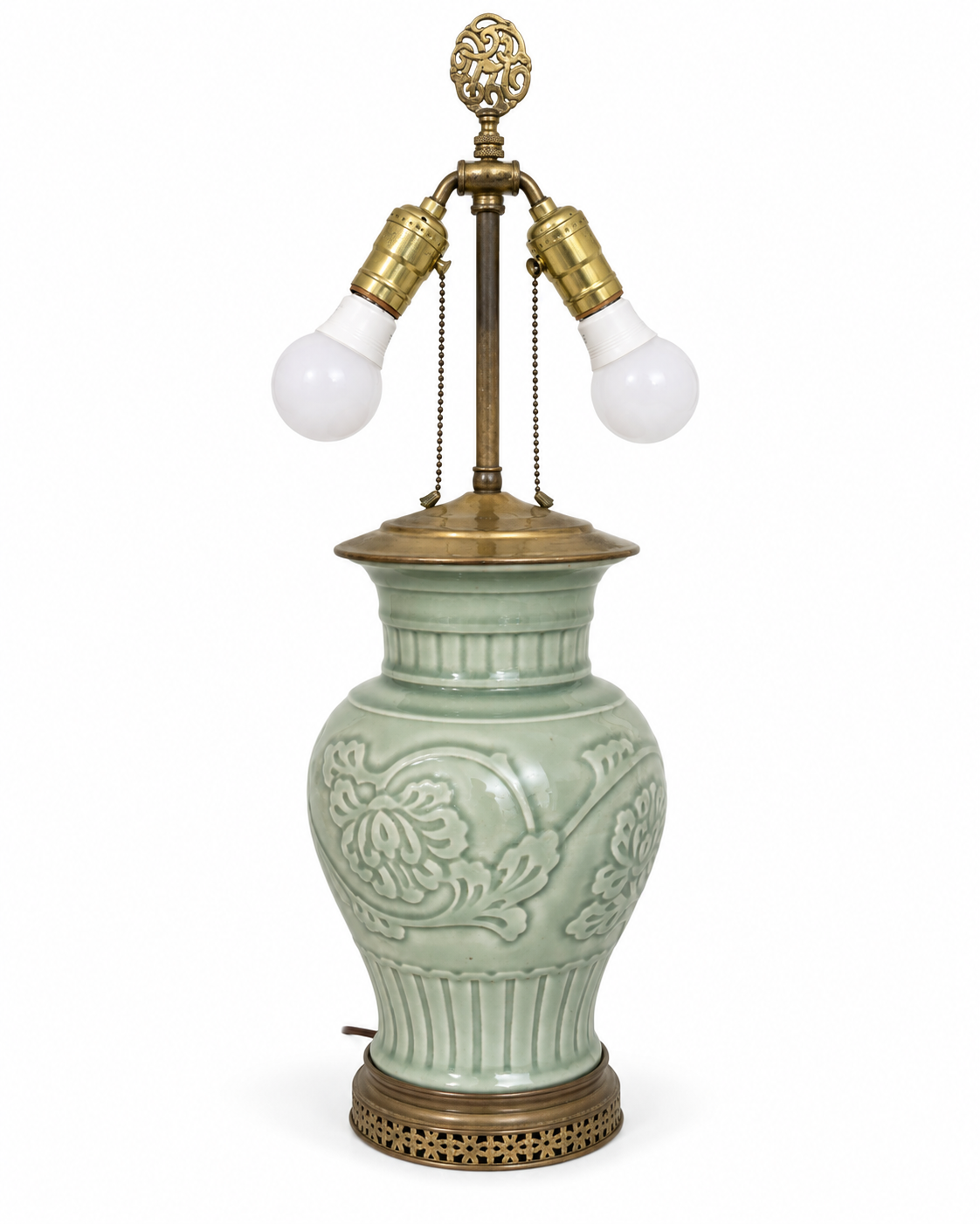 Celadon floral relief table lamp without a shade, showing twin sockets, harp and decorative finial.