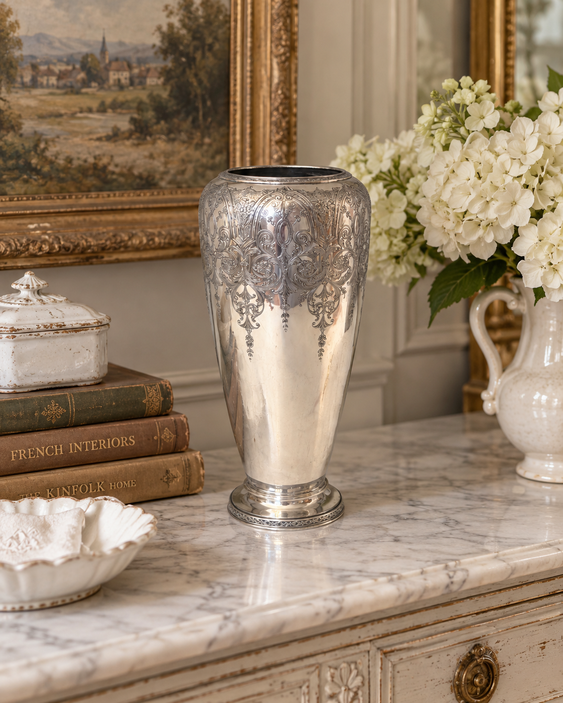 Ornate silver-plated pedestal vase with engraved Paisley detail, angled view on white background.