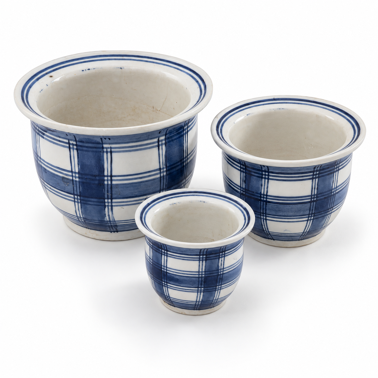Three graduated blue-and-white plaid ceramic planters arranged on a white background.