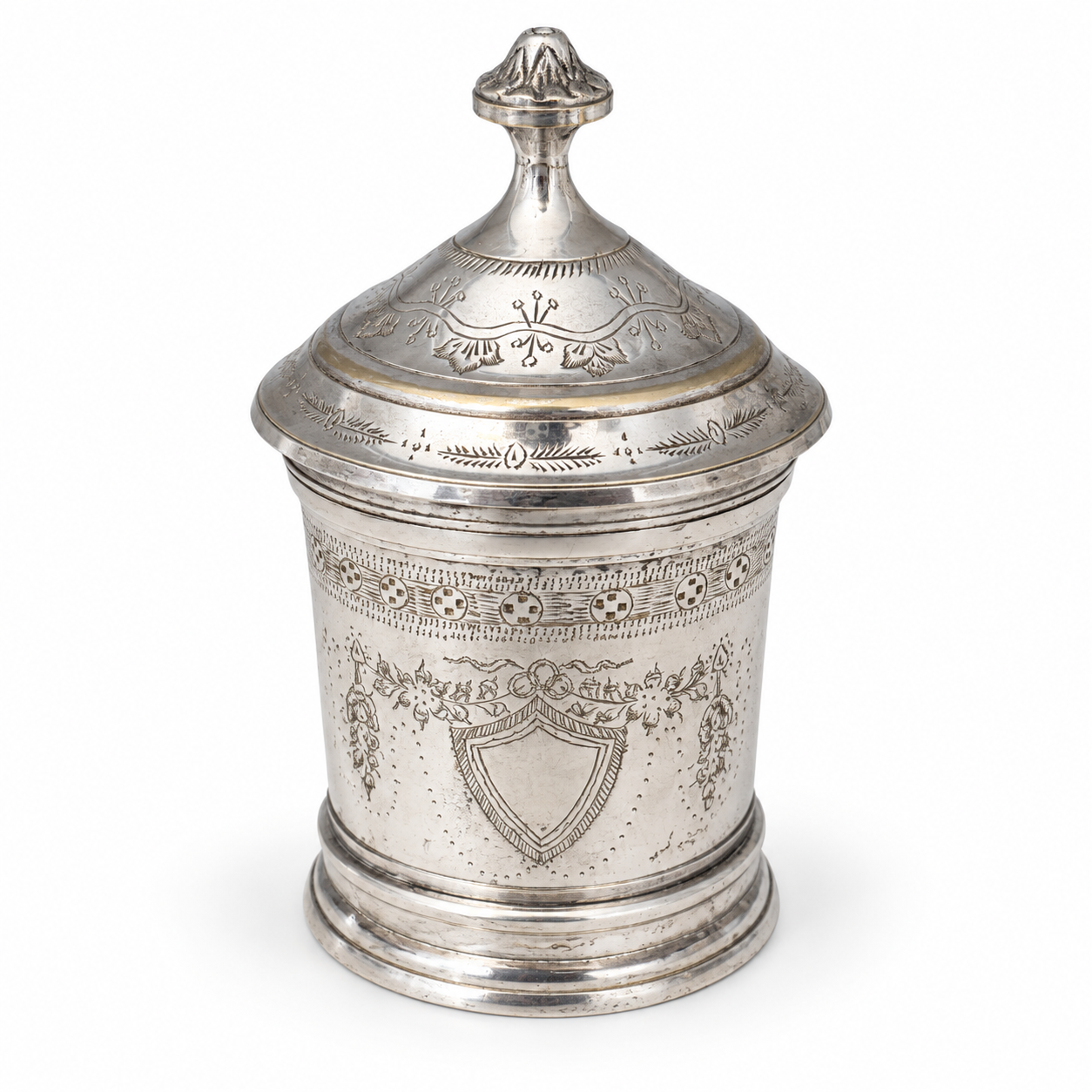 Silver-tone cylindrical jar with an engraved body, domed lid and tall finial.
