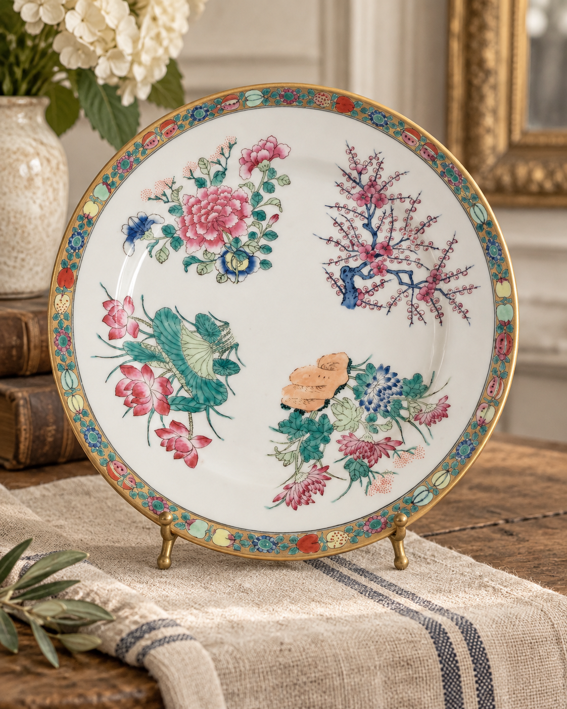 Chinese Four Seasons porcelain plate with peony, lotus, chrysanthemum and plum blossom in a collected grandmillennial interior