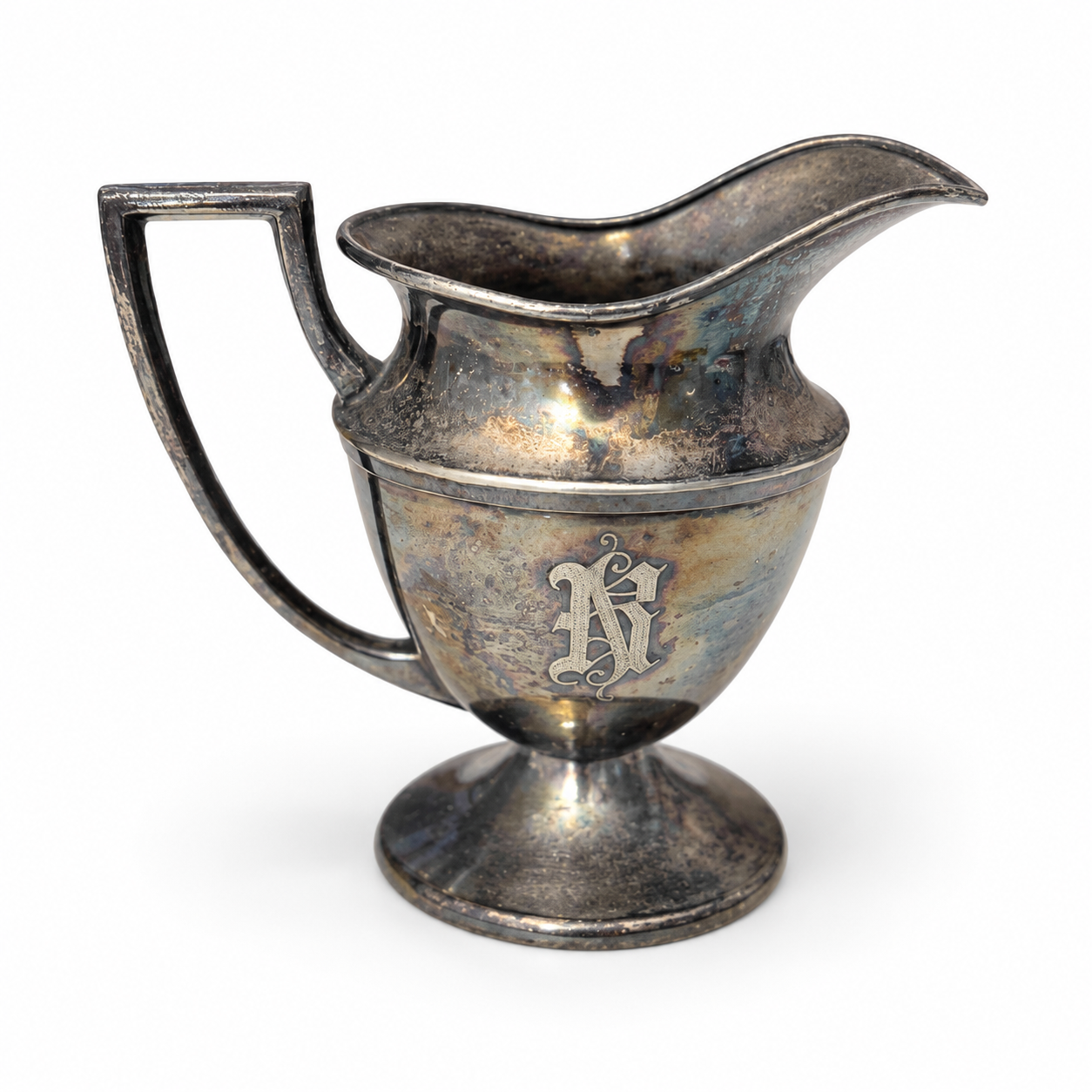 Elevated view of the creamer with a spout and handle.