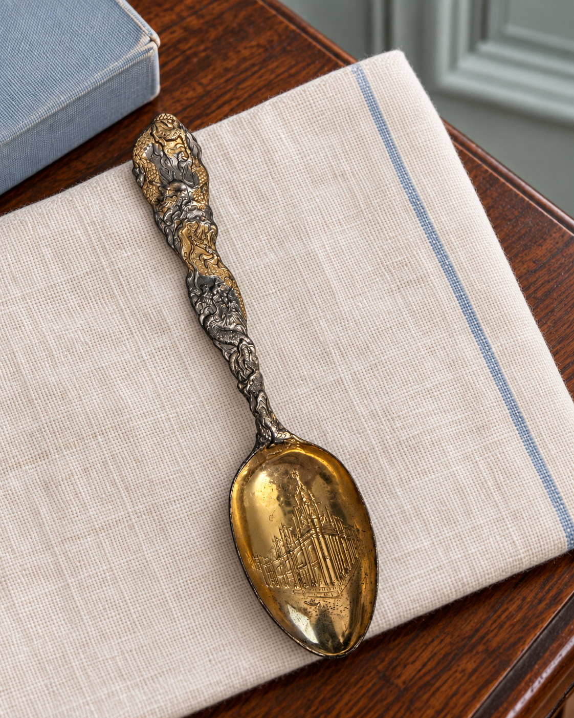 St. Louis World’s Fair souvenir spoon with a dragon handle and gold-toned Palace of Electricity bowl.